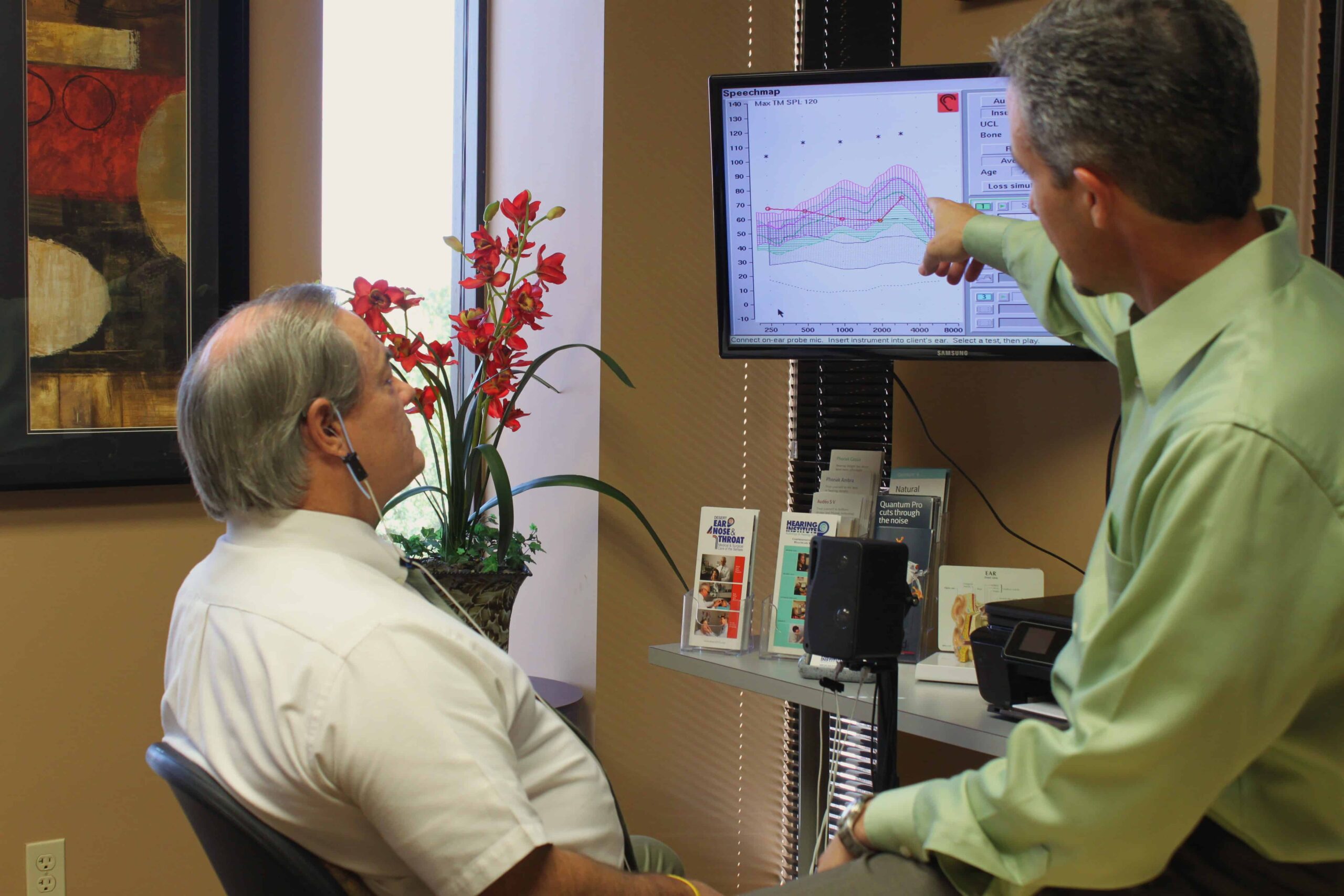 Dr. Wade S. Zarella AUD., CCC-A helping patient with hearing test