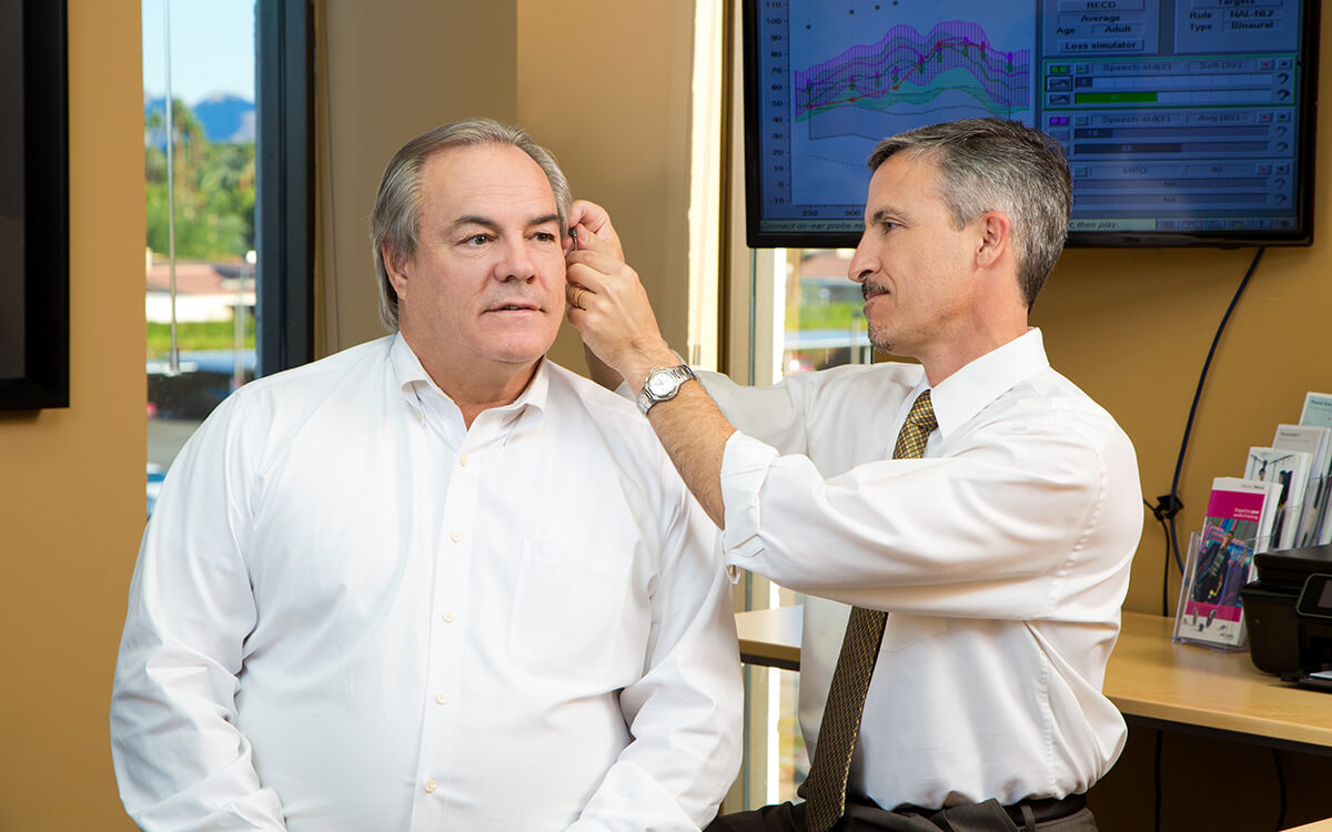 Man getting hearing aid fitted by Dr. Wade S. Zarella AUD., CCC-A